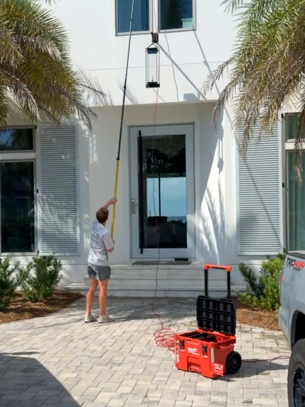 Eagle Shine cleaning high windows with a water-fed pole